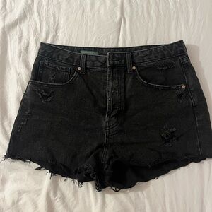 A size 8 pair of distressed black high waisted cutoff jean shorts from WildFable